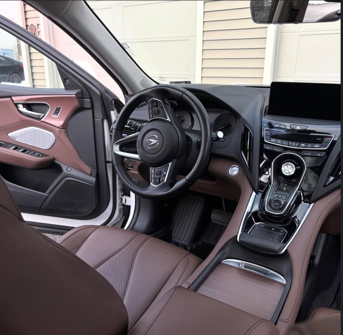 Interior of an Acura SUV after a full interior detail, showing cleaned leather seats and refreshed trim