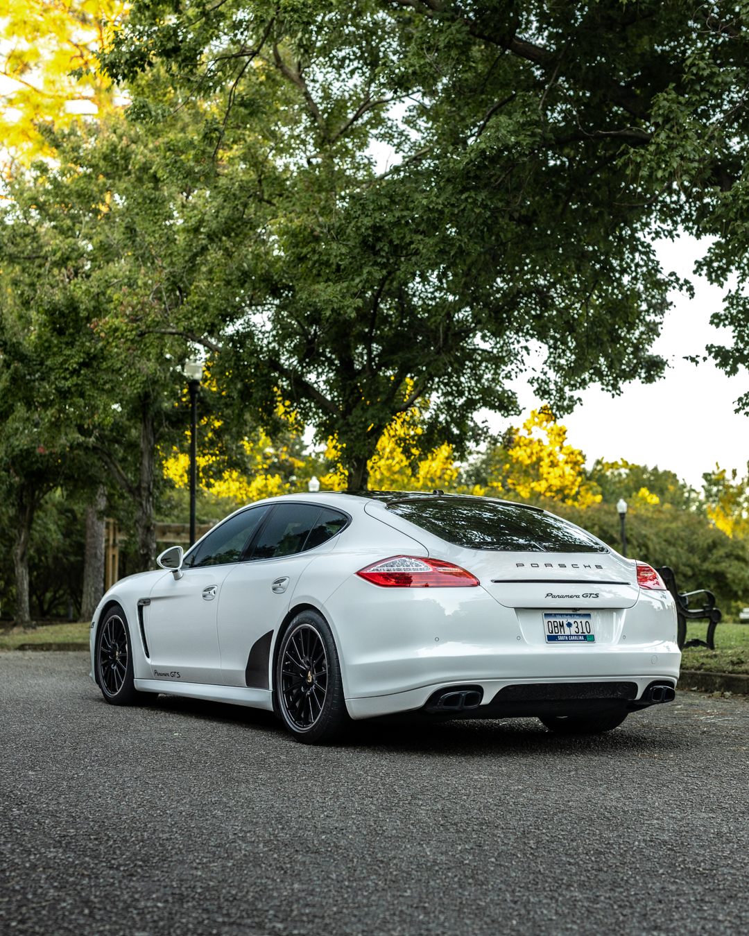 White Porsche Panamera sedan with a glass-like ceramic coated finish reflecting the sky