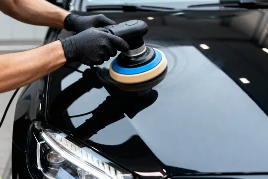 Machine polishing removing fine swirl marks from a vehicle hood in Hampshire County, Massachusetts