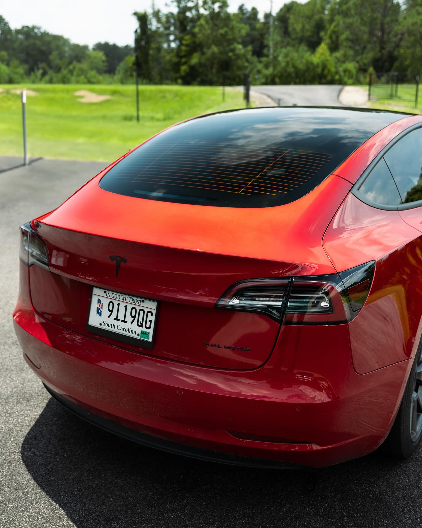Red Tesla Model 3 with a ceramic coated, swirl-free finish during a detail in Hampshire County, Massachusetts